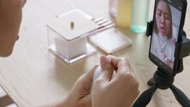 Real user review Influencer youtuber adult asia woman people blogger live talk skin care applying cosmetic on IG reel instagram tiktok shop. Vlogger happy side hustle blog vlog on online social media.