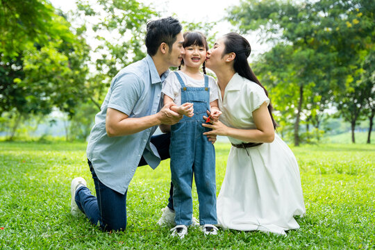 image of asian family playing in the park