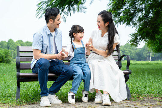 image of asian family playing in the park