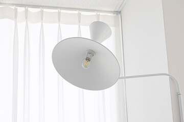 white round lamp between the white wall