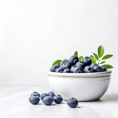 blueberries in a bowl on white background