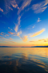 Colorful sea beach over mountains sunrise with deep blue sky and sunbeams. natural background