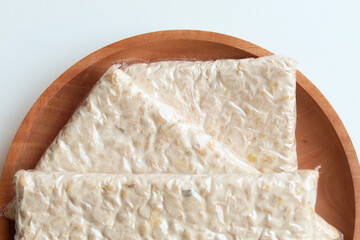 Tempeh or tempe, processed soy product, on wooden background. Isolated on white background. Flat lay or top view