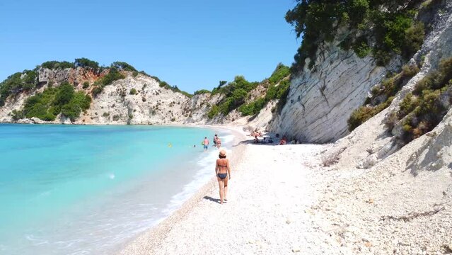 Portrait of a woman strolling on Gidaki Beach on the island of Ithaki or Ithaca in the Ionian Sea in the Mediterranean Sea of Greece