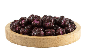 blackberry dragees in a wooden bowl