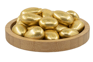 golden almond dragees in a wooden bowl