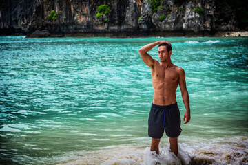 Handsome young man standing on a beach in Phuket Island, Thailand