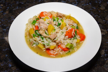 Traditional chicken soup with vegetables typically served in hospitals