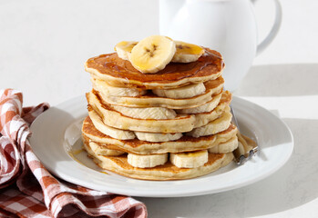 Pile of banana pancakes with honey