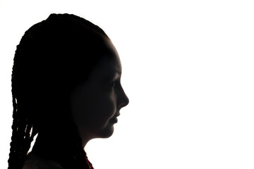 The girl portrait profile in silhouette shadow on studio. White background. Horizontally. 