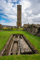 Tombs dug into the ground at the foot of the tower of St Andrews Cathedral in Scotland.