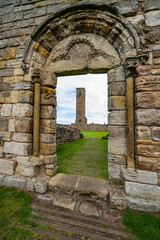 Ruined cathedral tower of Saint Andrews that can be seen through a stone arch from the Middle Ages, Scotland