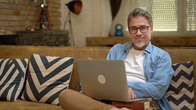 Man working with laptop at home office