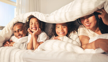 Happy family, bed and under blanket in home bedroom while comfortable, portrait and together....