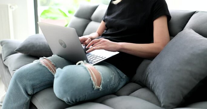 Woman works remotely on laptop at home. App for freelancers surfing internet