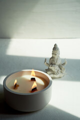 Goddess Lakshmi and a candle with three wooden wicks. Esotericism, religion. Abundance