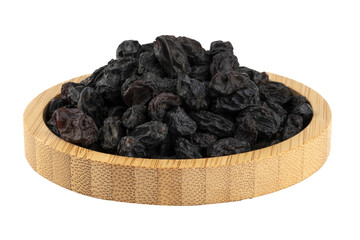 pitted sun dried black grapes in a wooden bowl