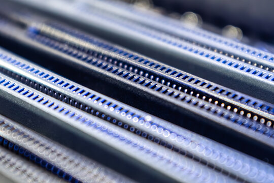 Blue DDR RAM memory slots sockets on motherboard close-up, desktop PC. Computer hardware chipset components background