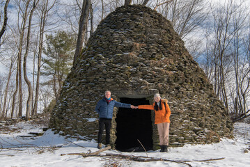 a couple holding hands at the beehive kiln