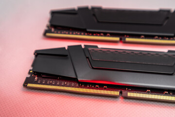 DDR4 DRAM memory modules in red light. Computer RAM chip close-up on white. Desktop PC memory parts for assemble