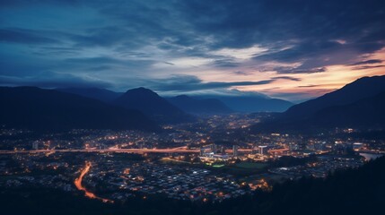 Obraz premium Cinematic aerial shot of a city just after sunset with stunning background