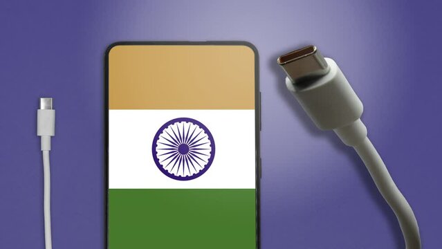 USB-C cable and a smartphone with the Indian Flag on screen