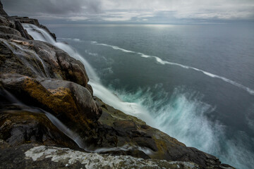Bosdalafossur waterfall at slave cliff and floating lake, Traelanipa, Sorvagsvatn, Vagar, Faroe Islands 