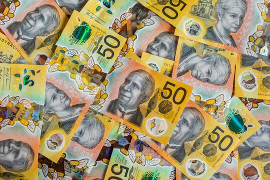 Australian currency - cash of fifty dollar notes scattered and filling frame