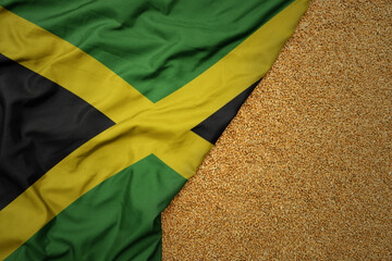 wheat grain on the waving colorful big national flag of jamaica .