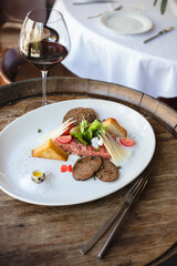 Restaurant serving dishes, waiter, banquet, set table with white tablecloth and chic dish.