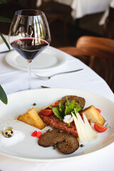 Restaurant serving dishes, waiter, banquet, set table with white tablecloth and chic dish.