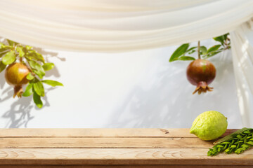 Jewish holiday Sukkot celebration background with decorations on wooden table