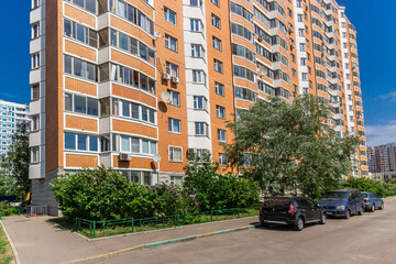 Landscaped courtyard area with blooming lilac bushes in a modern residential complex .against the blue sky.