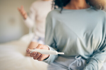 Fototapeta na wymiar Hands, woman and bed with pregnancy test, closeup and home for results, planning or news to start family. Girl, exam and notification in bedroom, apartment and anxiety for maternity, future or baby