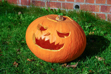 Halloween carved pumpkin with evil face. Jack o lantern decoration during autumn Halloween celebration