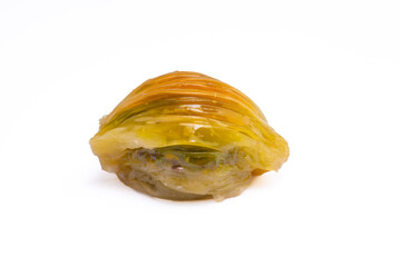 Mussel shaped baklava with pistachio on white background