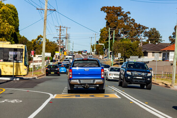 Busy traffic at school zone intersection with yellow bus