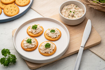 Butter cracker with tuna spread on cutting board,snack food