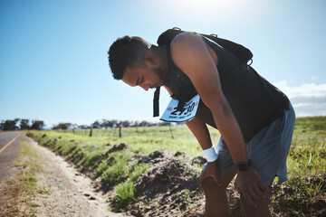 Fitness, breathing and tired man in road for training, workout or intense cardio outdoor...