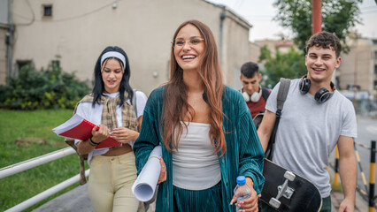 group of teenage students gen z walk in front of school university