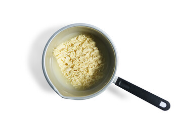 Yellow istan noodles are ready to be cooked in a pot on a plain background