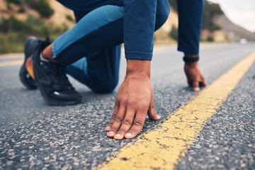 Hands, running and a man at the start of his road workout for cardio training in preparation of a marathon. Fitness, line and a male runner or athlete getting ready for a challenge on the street