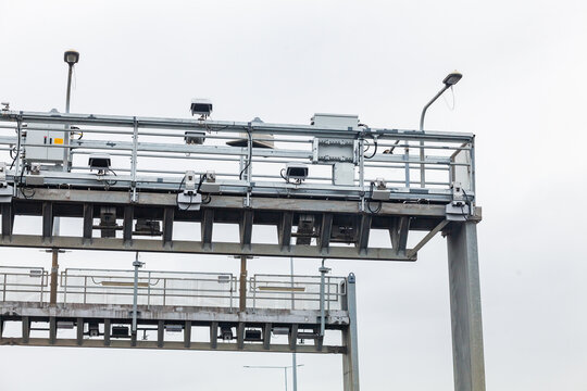 Grey infrastructure with cameras above road for tolls