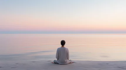 Foto op Plexiglas individual meditating at sunrise on a pristine beach, calm sea, pastel sky with first light of dawn, minimalist aesthetic © Marco Attano