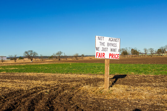 Sign protesting land acquisition for Singleton Bypass without enough compensation to replace farm