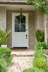 front entrance to brick building with white Dutch door