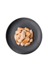 Delicious chicken slices baked with spices and herbs on a round ceramic plate