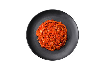 Dried squid chopped into slices and seasoned with sesame seeds and spices