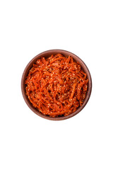 Dried squid chopped into slices and seasoned with sesame seeds and spices