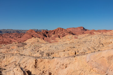 Scenic view of from Silica Dome viewpoint overlooking the Valley of Fire State Park in Mojave desert, Nevada, USA. Landscape of Aztek sandstone rock formations. Hot temperature in arid vegetation
